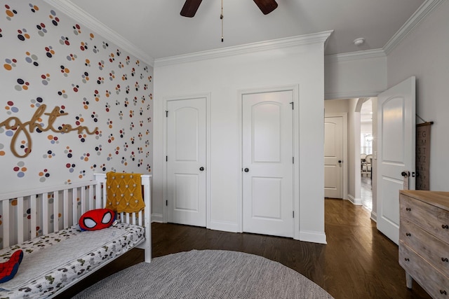 bedroom with dark hardwood / wood-style flooring, ornamental molding, and ceiling fan