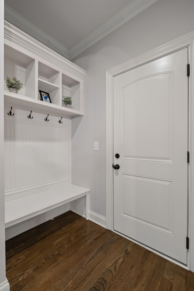 mudroom featuring dark wood-type flooring and ornamental molding