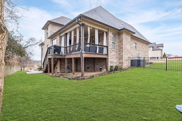 back of property featuring a wooden deck, a yard, and cooling unit