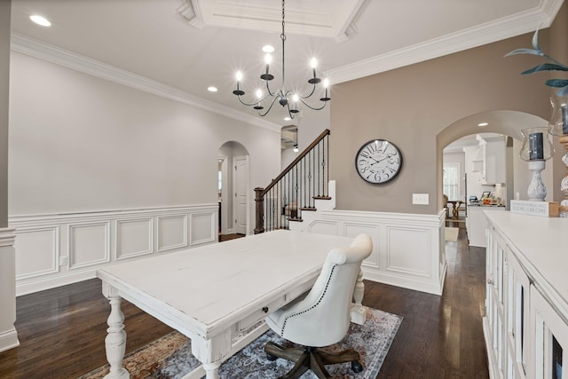 dining area featuring dark wood-type flooring, crown molding, and a chandelier