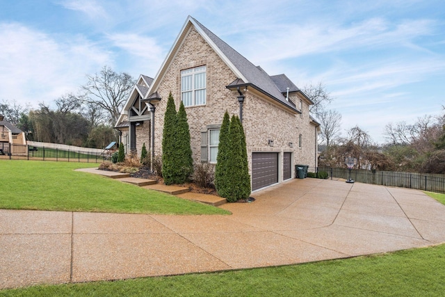 view of home's exterior featuring a garage and a yard