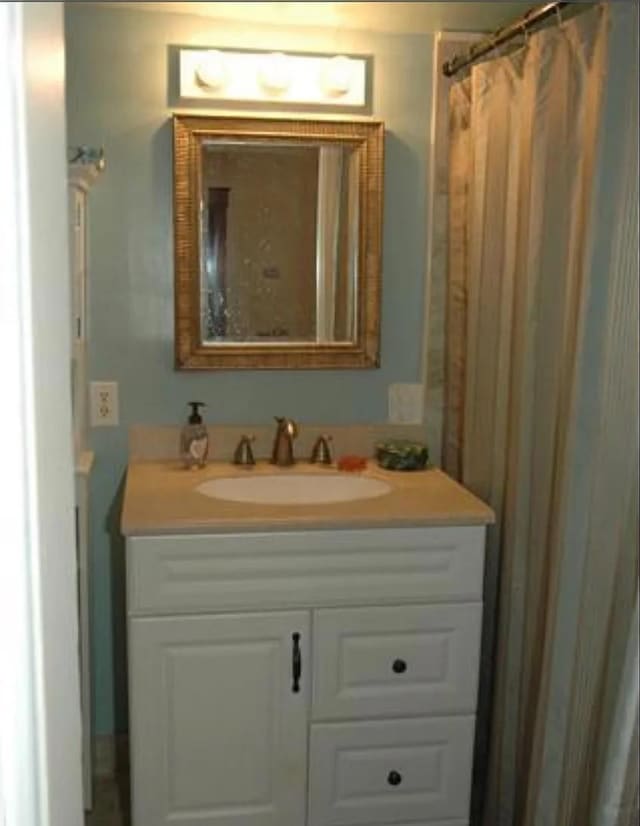 bathroom with vanity and a shower with shower curtain