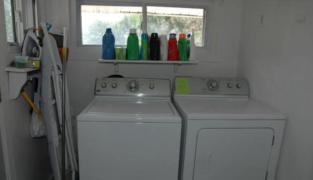 clothes washing area with washer and clothes dryer