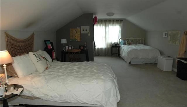 bedroom featuring vaulted ceiling and carpet floors