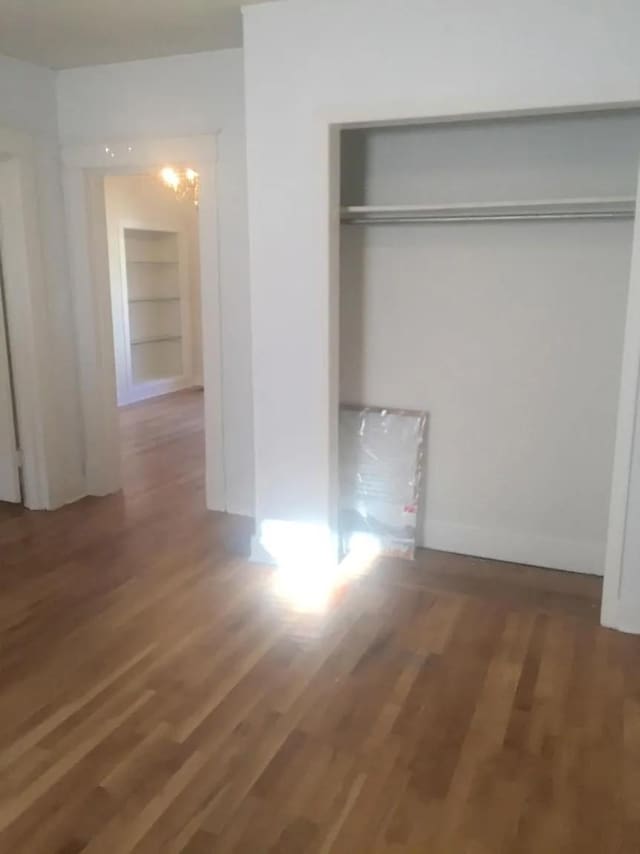 unfurnished bedroom featuring hardwood / wood-style flooring and a closet