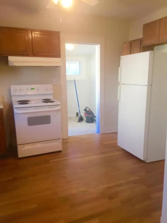 kitchen featuring hardwood / wood-style flooring and white appliances