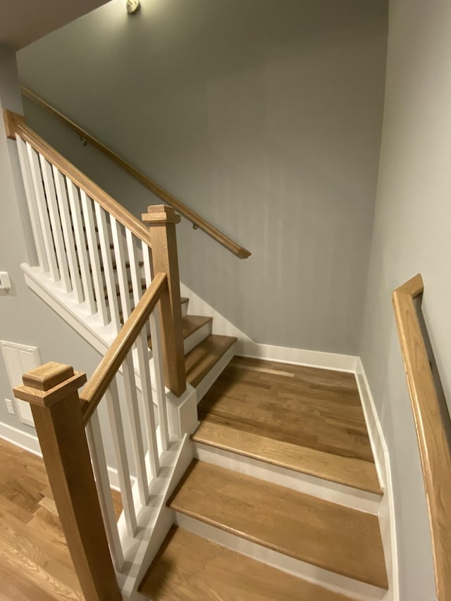 stairway with wood-type flooring