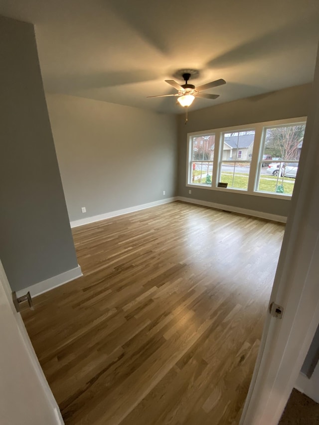 unfurnished room with hardwood / wood-style flooring and ceiling fan