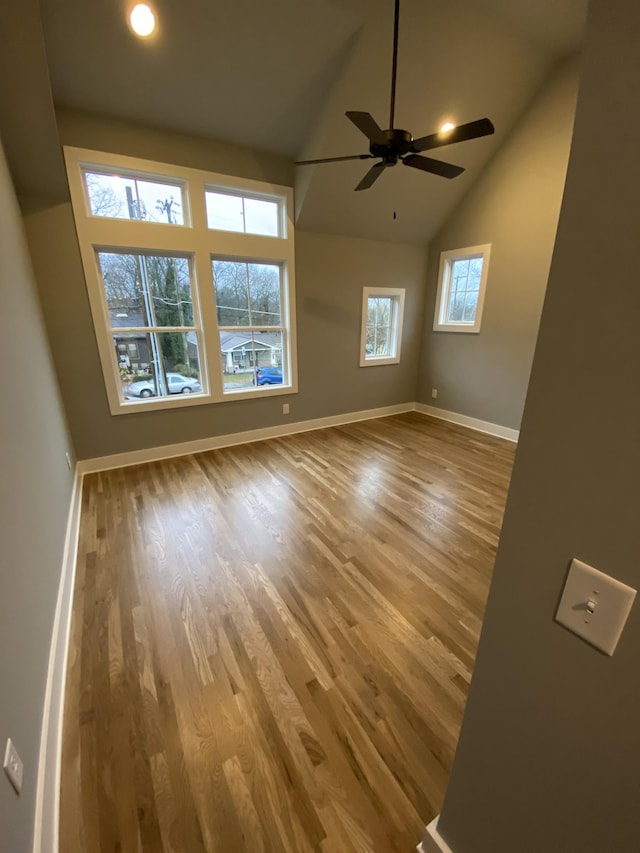 spare room with vaulted ceiling, ceiling fan, and light hardwood / wood-style floors