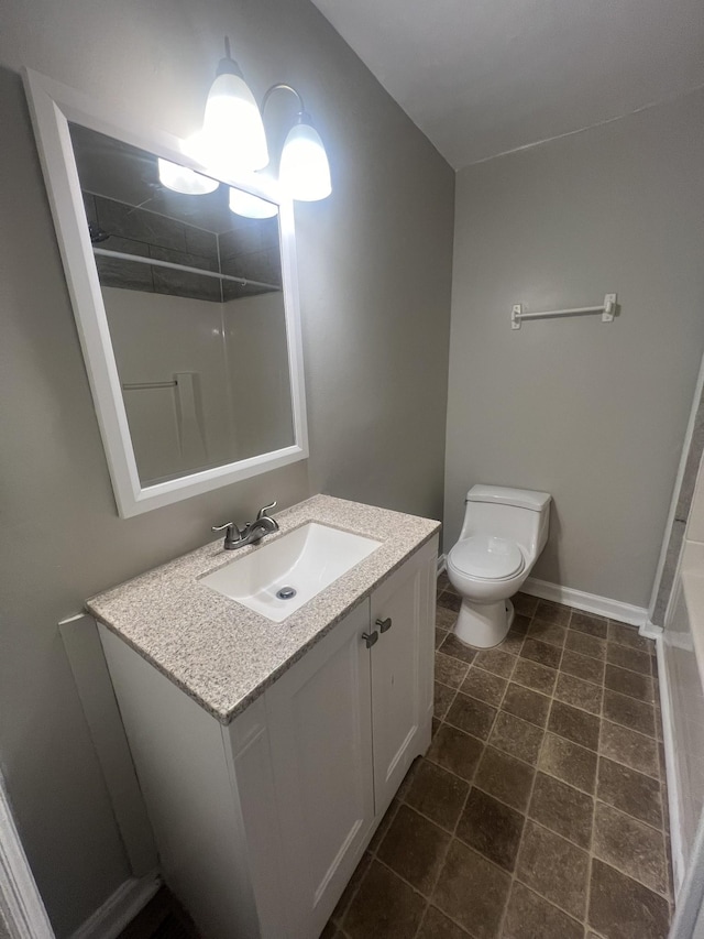 bathroom featuring vanity, toilet, and walk in shower