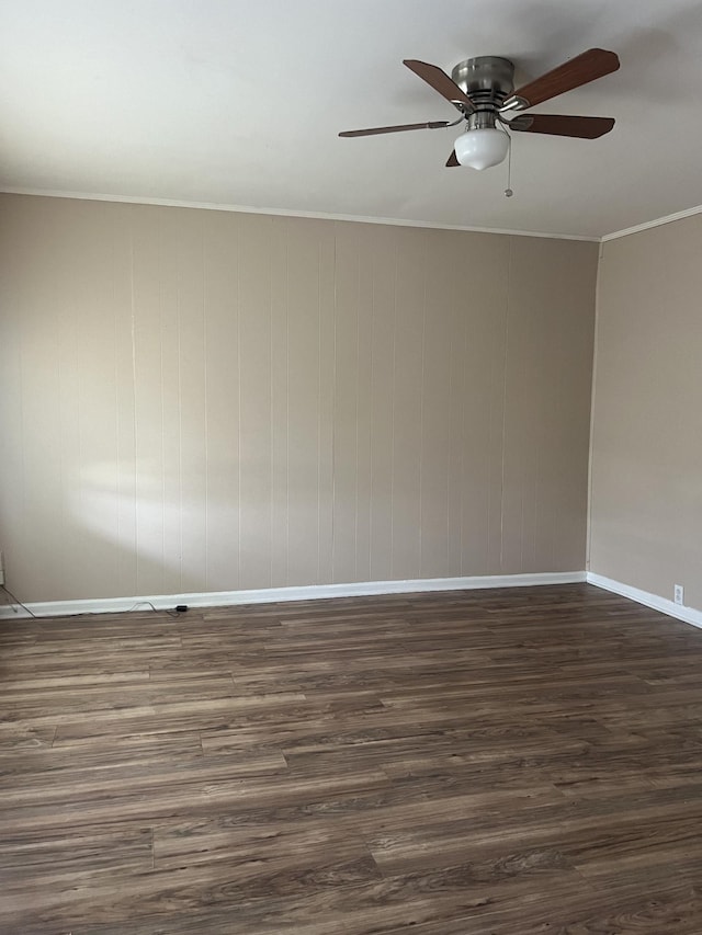 empty room with crown molding, dark hardwood / wood-style floors, and ceiling fan