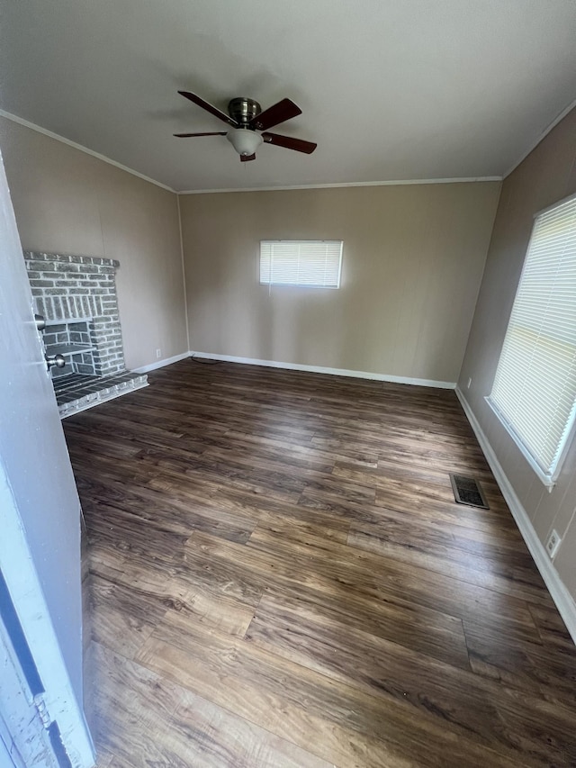 spare room featuring ceiling fan, ornamental molding, and dark hardwood / wood-style flooring