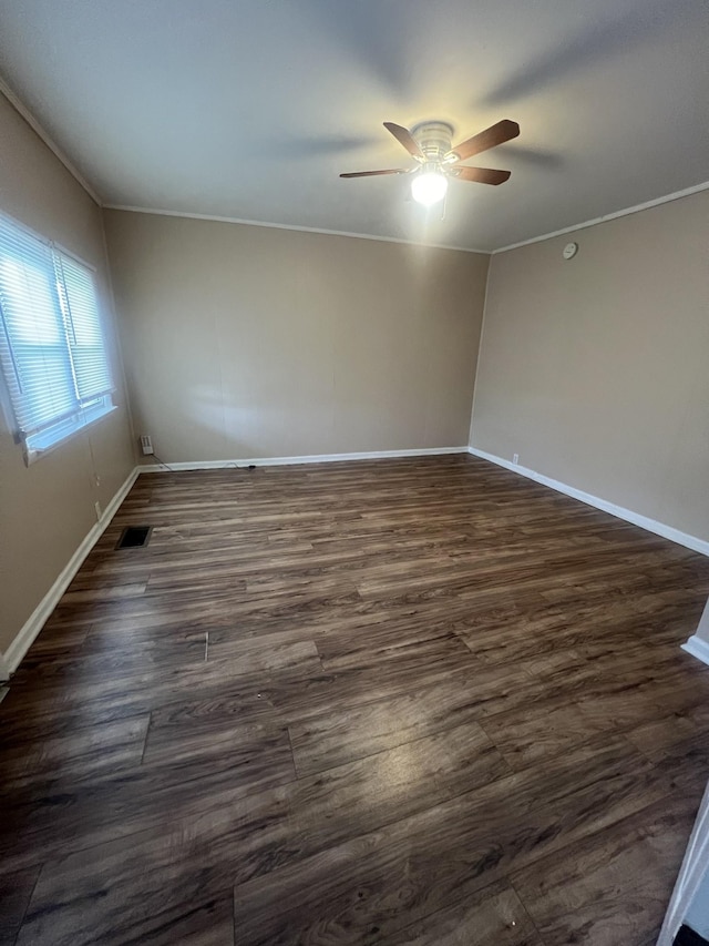 unfurnished room featuring crown molding, dark hardwood / wood-style floors, and ceiling fan