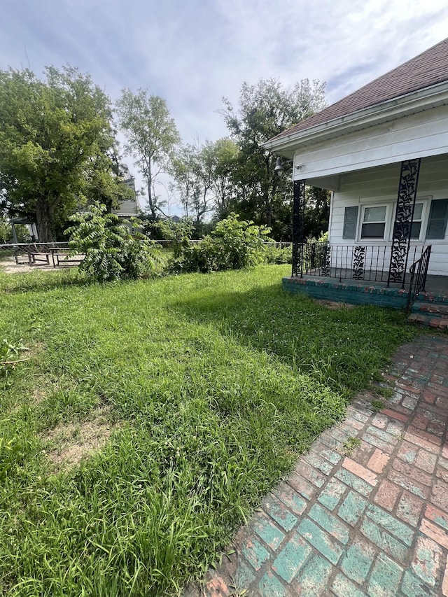 view of yard with covered porch