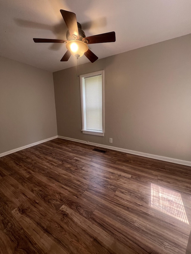 empty room with dark hardwood / wood-style flooring