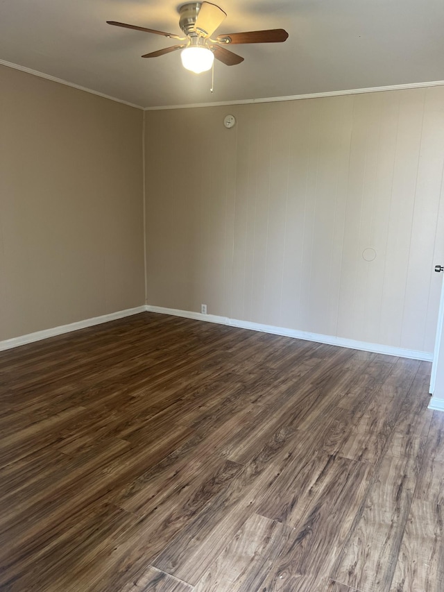 spare room featuring ornamental molding, dark wood-type flooring, and ceiling fan