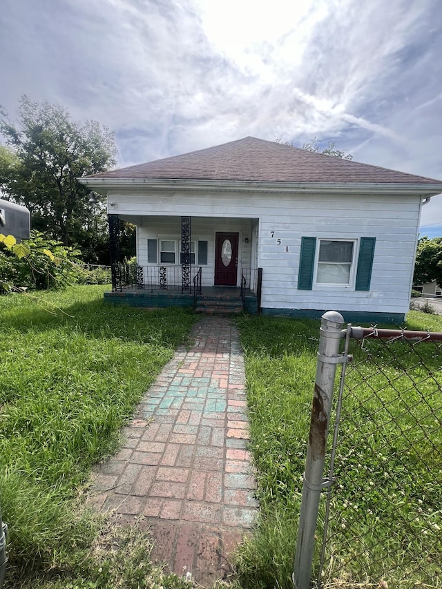 view of front of house with a porch and a front yard