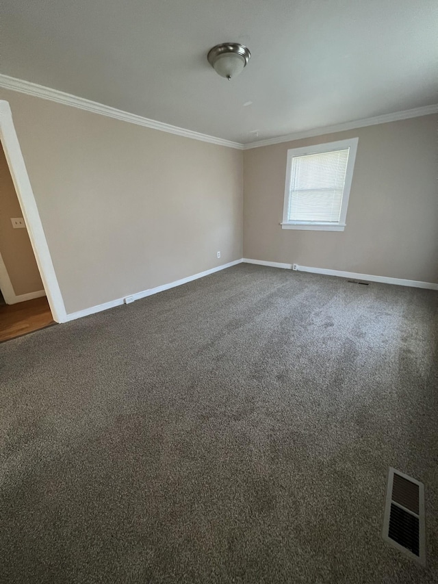 unfurnished room featuring crown molding and carpet flooring