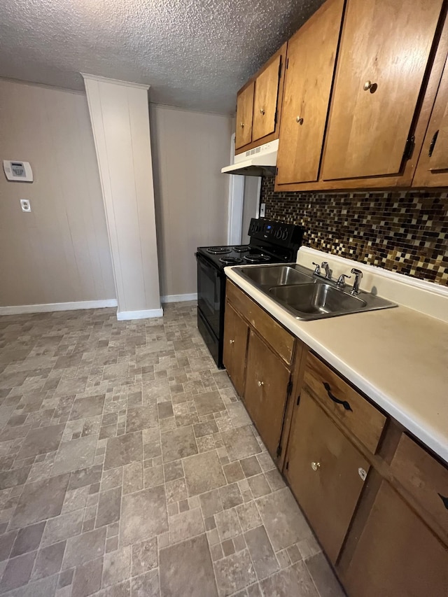 kitchen with sink, black range with electric cooktop, decorative backsplash, and a textured ceiling