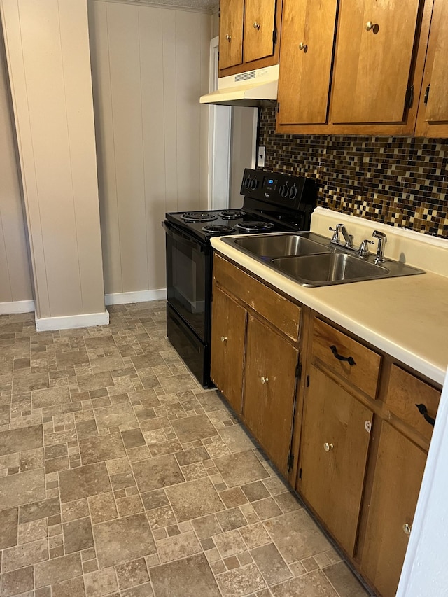 kitchen with backsplash, electric range, and sink