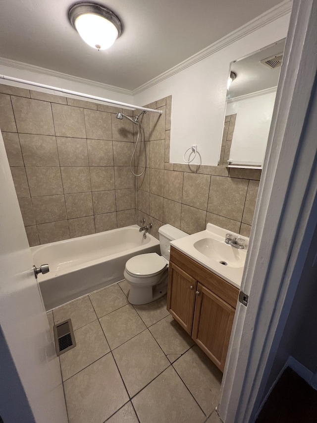 full bathroom featuring toilet, tile walls, vanity, tiled shower / bath combo, and tile patterned flooring