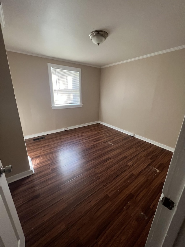 unfurnished room featuring ornamental molding and dark hardwood / wood-style floors