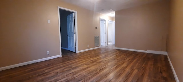 empty room with dark hardwood / wood-style floors