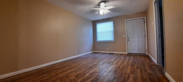 empty room featuring ceiling fan and dark hardwood / wood-style flooring