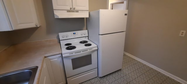 kitchen featuring sink, white cabinets, and white appliances