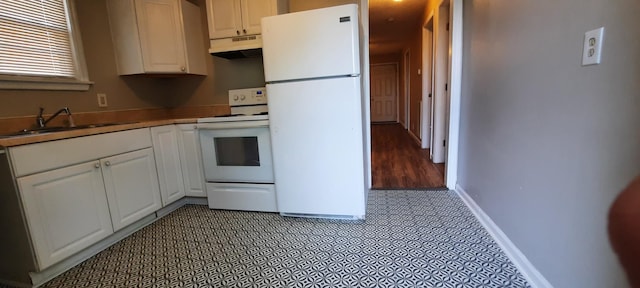 kitchen featuring white appliances, tile patterned floors, sink, and white cabinets