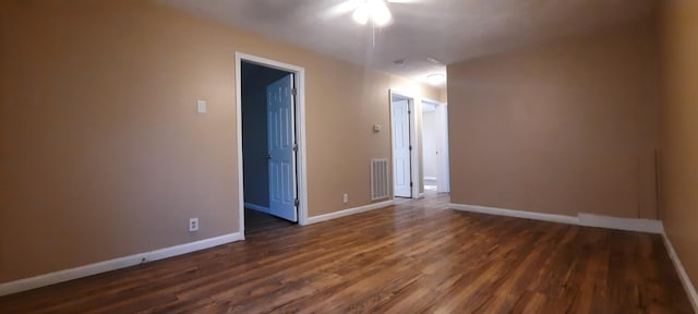 empty room featuring dark wood-type flooring