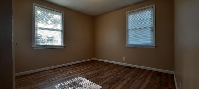 spare room featuring dark hardwood / wood-style flooring