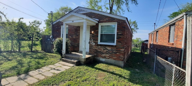 bungalow-style house with a front lawn