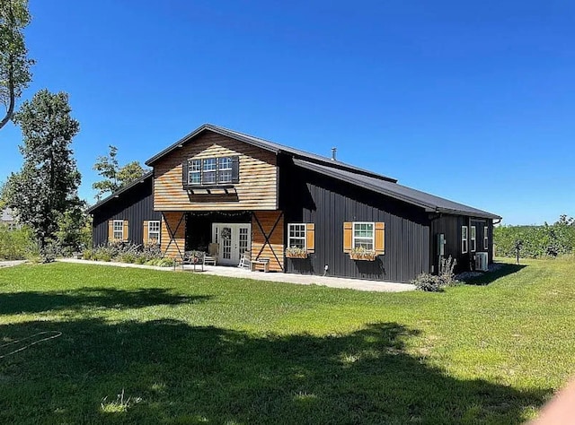 back of property featuring a yard, cooling unit, a patio area, and french doors