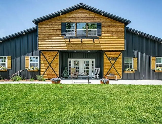 rear view of house with a lawn and french doors