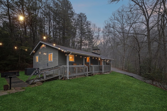 view of front of home with a yard and cooling unit