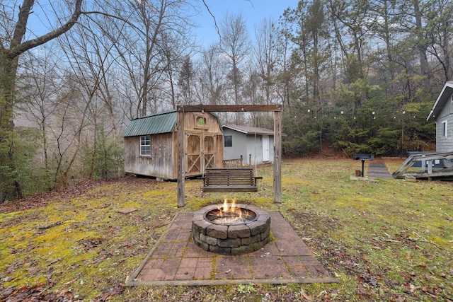 view of yard with a storage unit and an outdoor fire pit