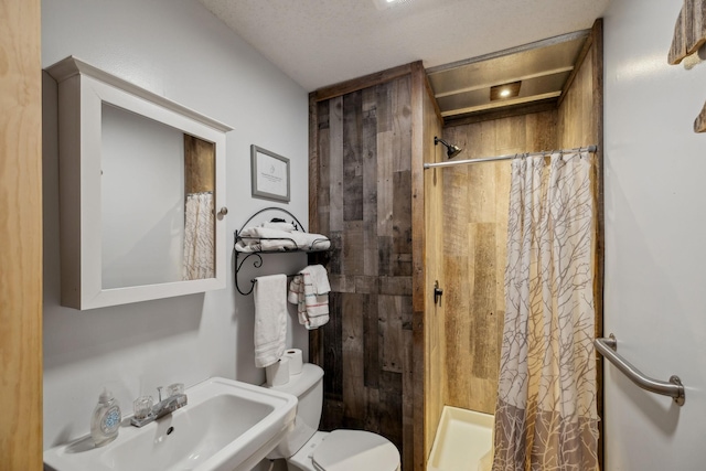 bathroom with toilet, sink, and walk in shower