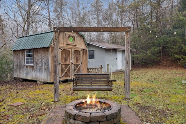 view of outbuilding with a fire pit