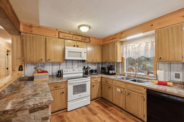 kitchen featuring sink, light hardwood / wood-style flooring, a textured ceiling, white appliances, and decorative backsplash