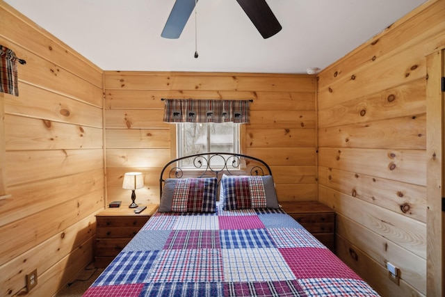 unfurnished bedroom featuring ceiling fan and wood walls