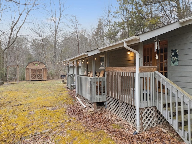 view of side of property with a deck and a shed