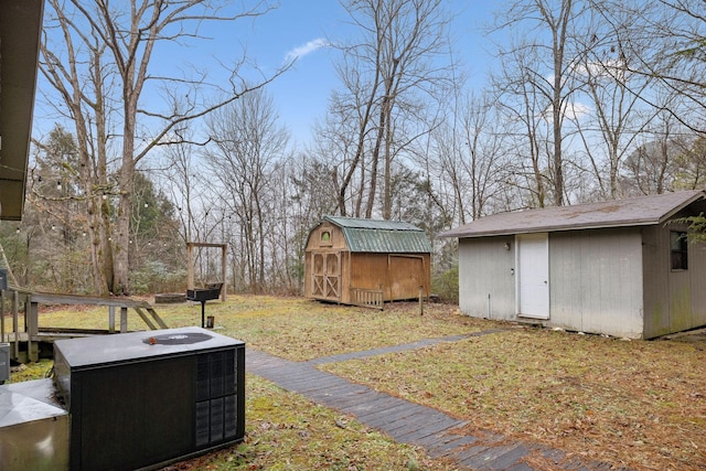 view of yard with cooling unit and a storage shed