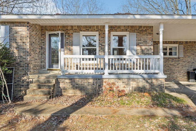 view of exterior entry featuring a porch