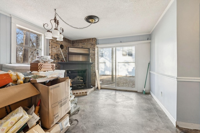 living room featuring ornamental molding, a fireplace, concrete floors, and a textured ceiling