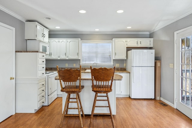 kitchen featuring white cabinetry, ornamental molding, white appliances, and light hardwood / wood-style flooring