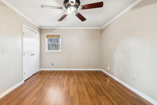 unfurnished room featuring crown molding, ceiling fan, and light wood-type flooring