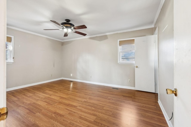 spare room featuring hardwood / wood-style flooring, crown molding, and ceiling fan