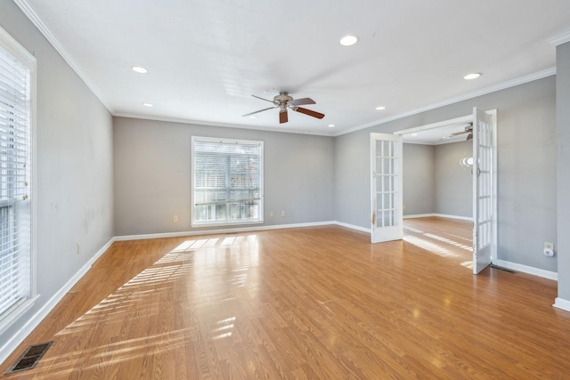 spare room with french doors, ceiling fan, crown molding, and light wood-type flooring