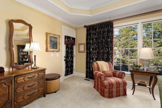 sitting room featuring ornamental molding, a tray ceiling, and light carpet